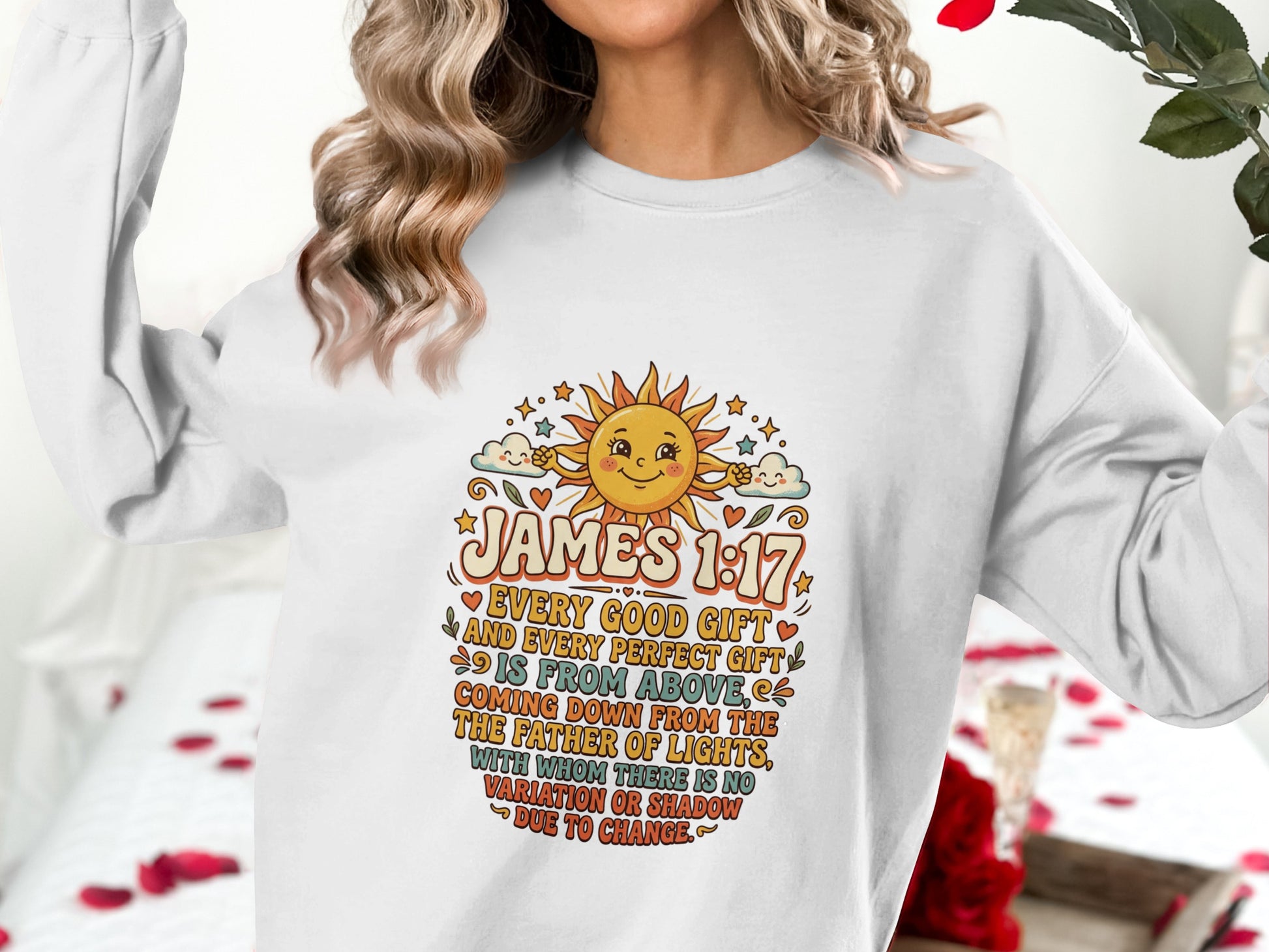 White sweatshirt with "James 1:17" bible verse and a sun graphic.