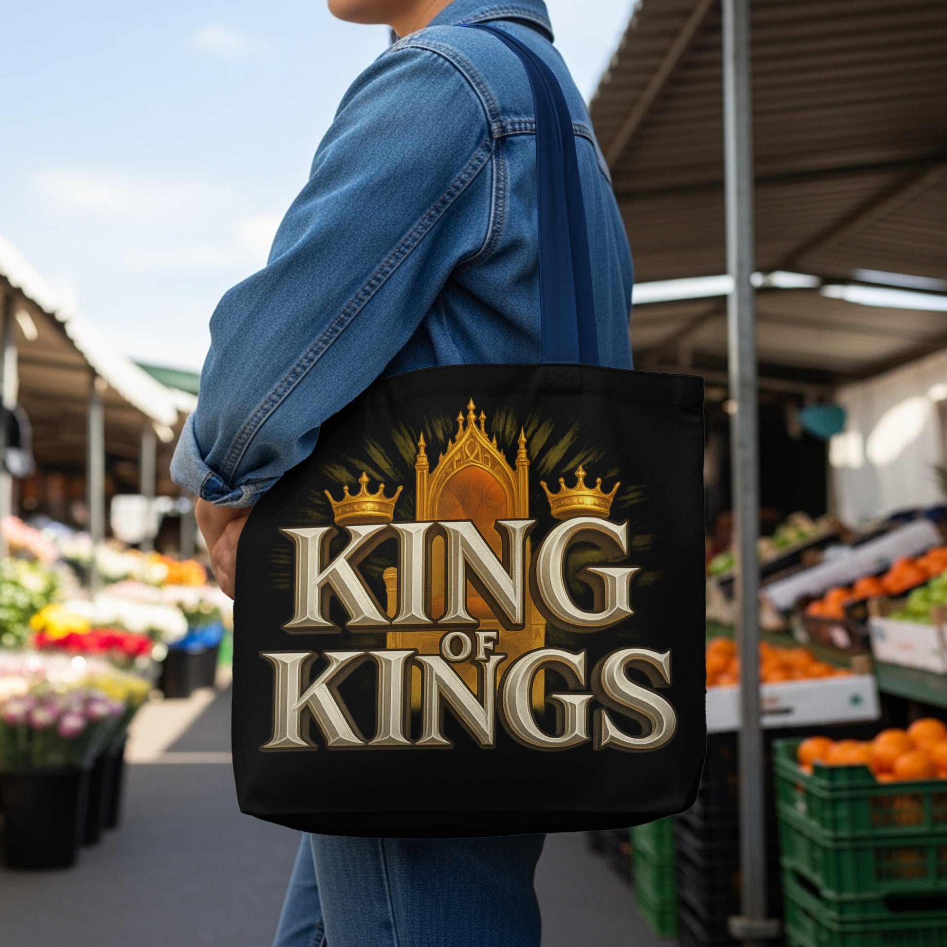 Black tote bag with gold crowns and text "KING OF KINGS" over a throne.