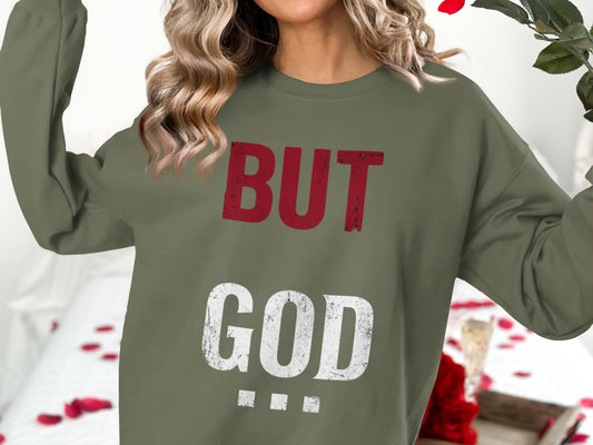 Olive sweatshirt with "BUT GOD" text in distressed red and white.