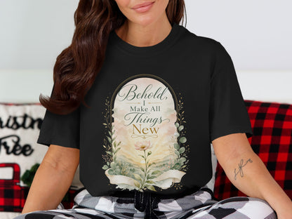 Black t-shirt with floral design and text "Behold, I Make All Things New".
