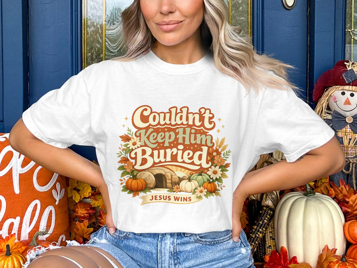 White t-shirt with graphic saying "Couldn't Keep Him Buried, Jesus Wins".