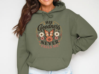 Olive green hoodie with "His Goodness Never Fails Me" text and floral butterfly design.