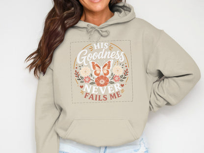 Beige hoodie with "His Goodness Never Fails Me" text and floral butterfly design.