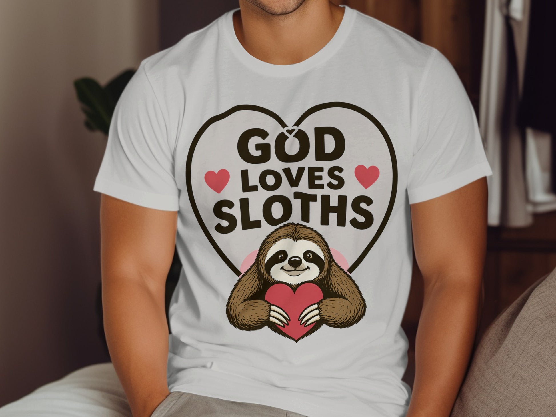 White t-shirt with "God Loves Sloths" and a sloth holding a heart.