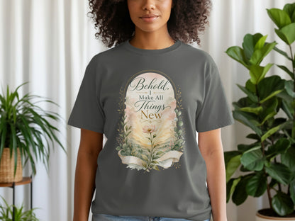 T-shirt with "Behold, I Make All Things New" text within an oval floral landscape design.