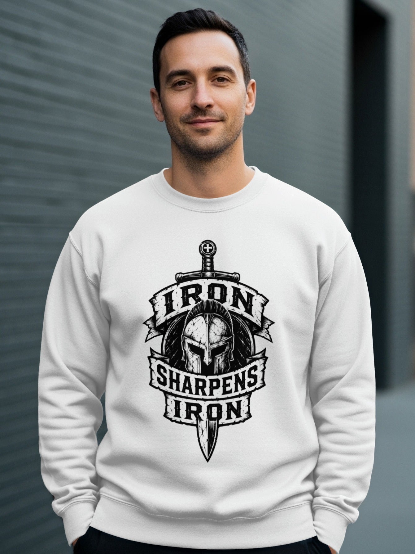 White sweatshirt with a graphic of a helmet, sword, and text "Iron Sharpens Iron".