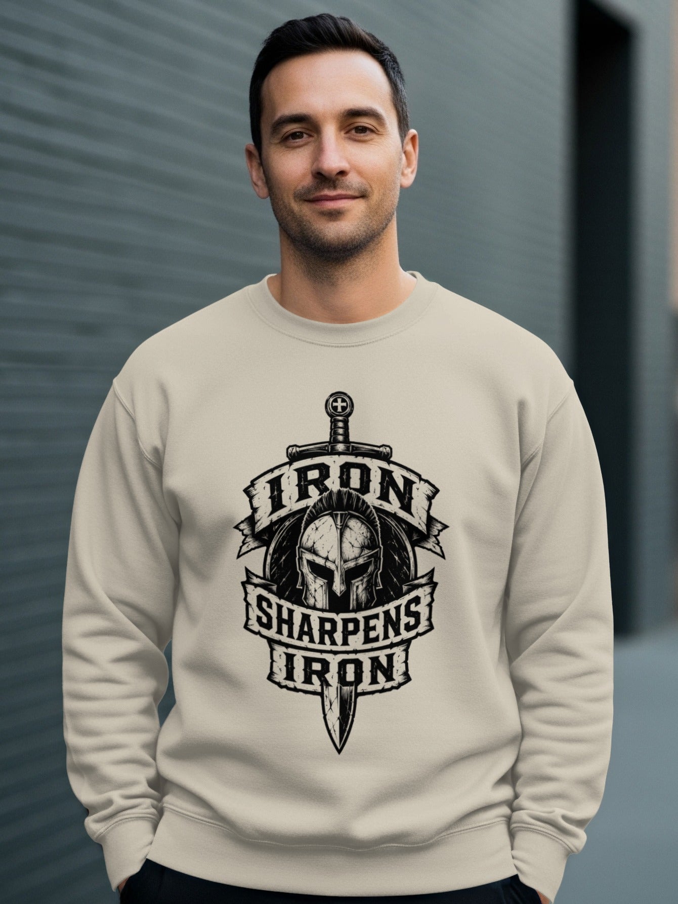 Cream sweatshirt with "Iron Sharpens Iron" shield and sword graphic.