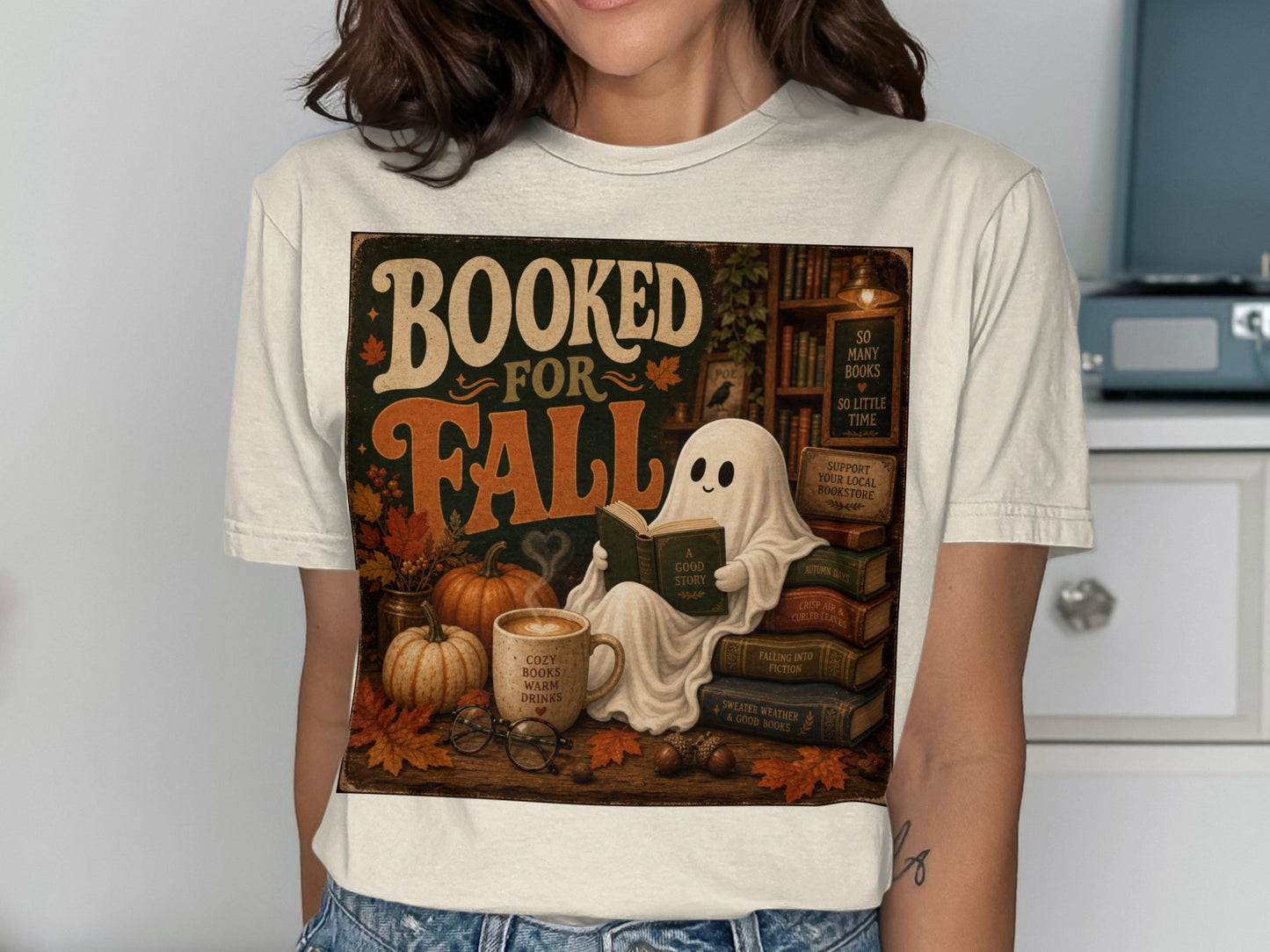 Booked for Fall graphic with ghost reading, pumpkins, and cozy autumn elements.