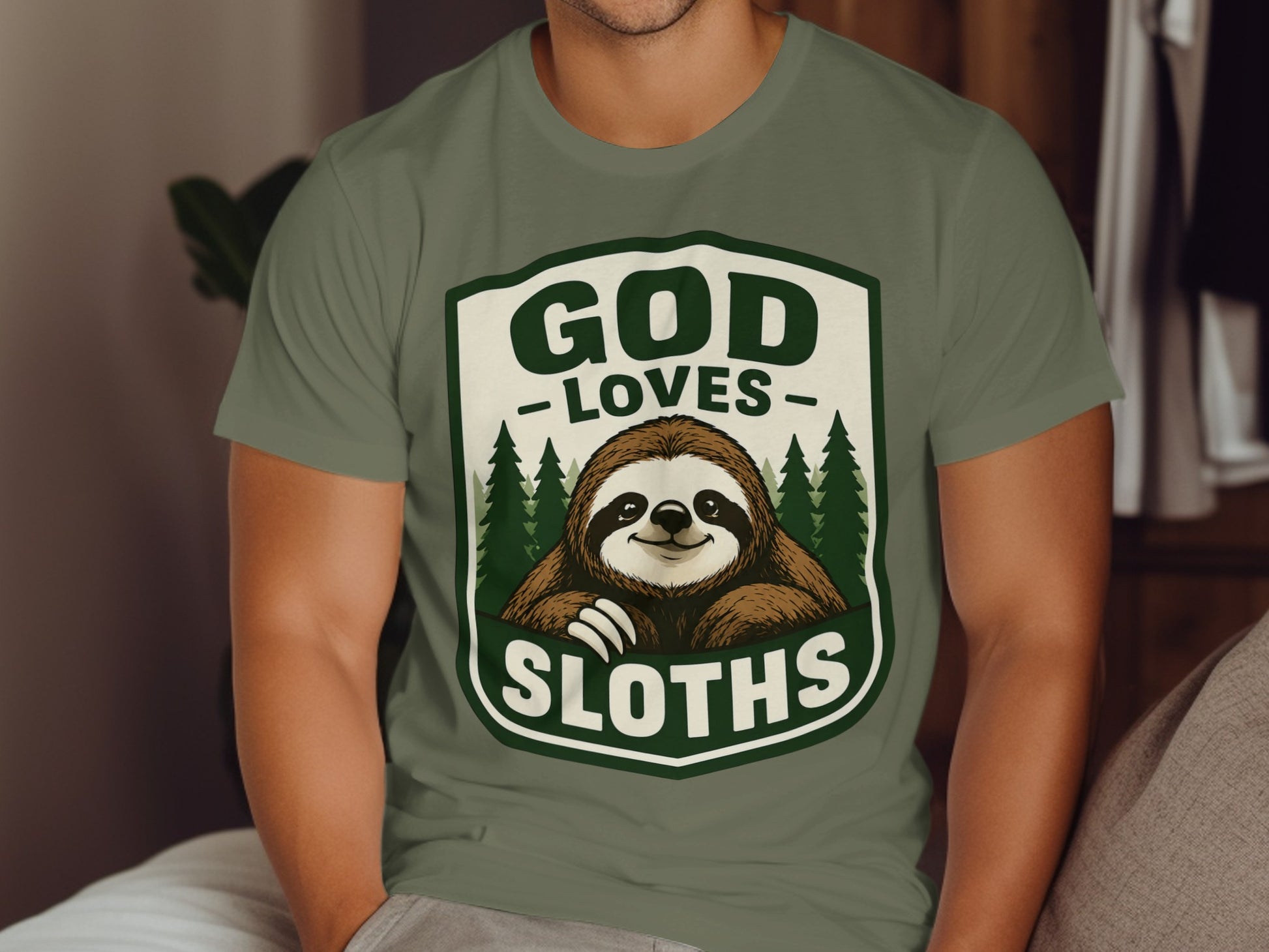 Green t-shirt with "God Loves Sloths" text and a smiling sloth illustration.