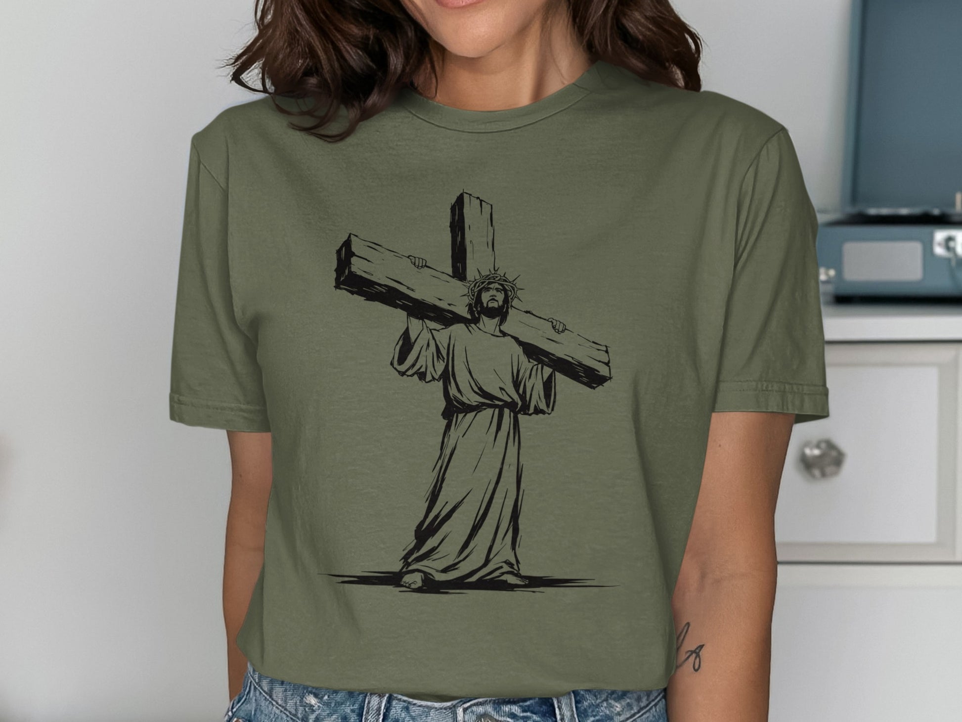 T-shirt graphic of Jesus carrying a large cross, wearing a crown of thorns.