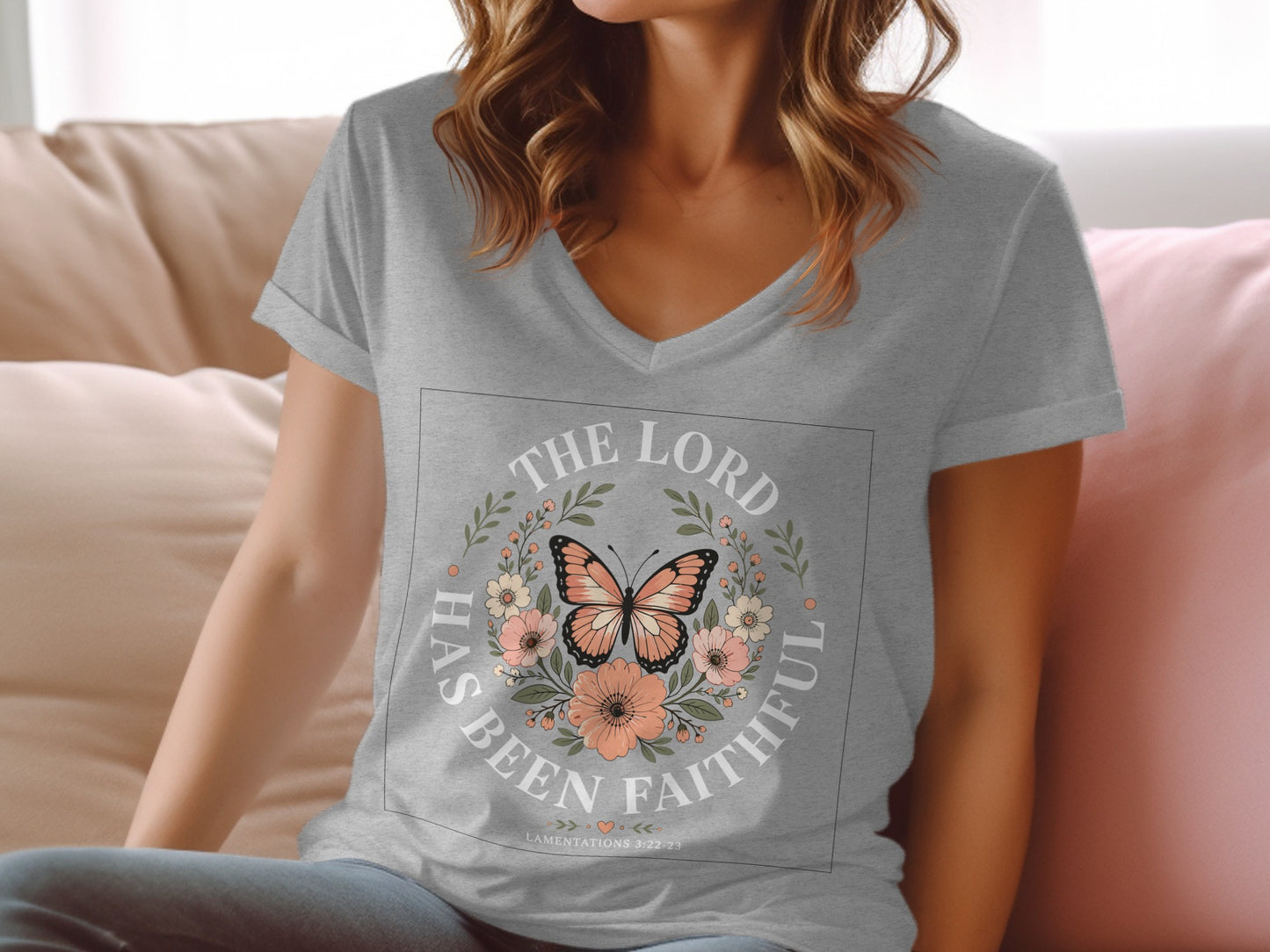 Grey v-neck t-shirt with "The Lord Has Been Faithful" text and a butterfly floral wreath.