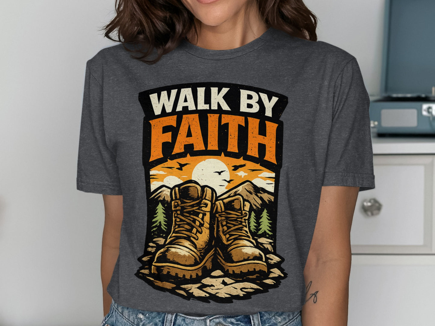 Hiking boots with "Walk by Faith" text and mountain sunset graphic.