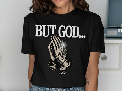 Black t-shirt with praying hands graphic and "BUT GOD..." text.