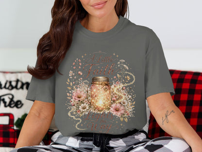 Gray t-shirt featuring a mason jar with lights, surrounded by flowers, and text "A Little Faith Lights the Way".