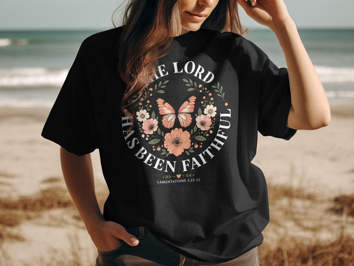 Black t-shirt with floral and butterfly design and "The Lord has been faithful" text.