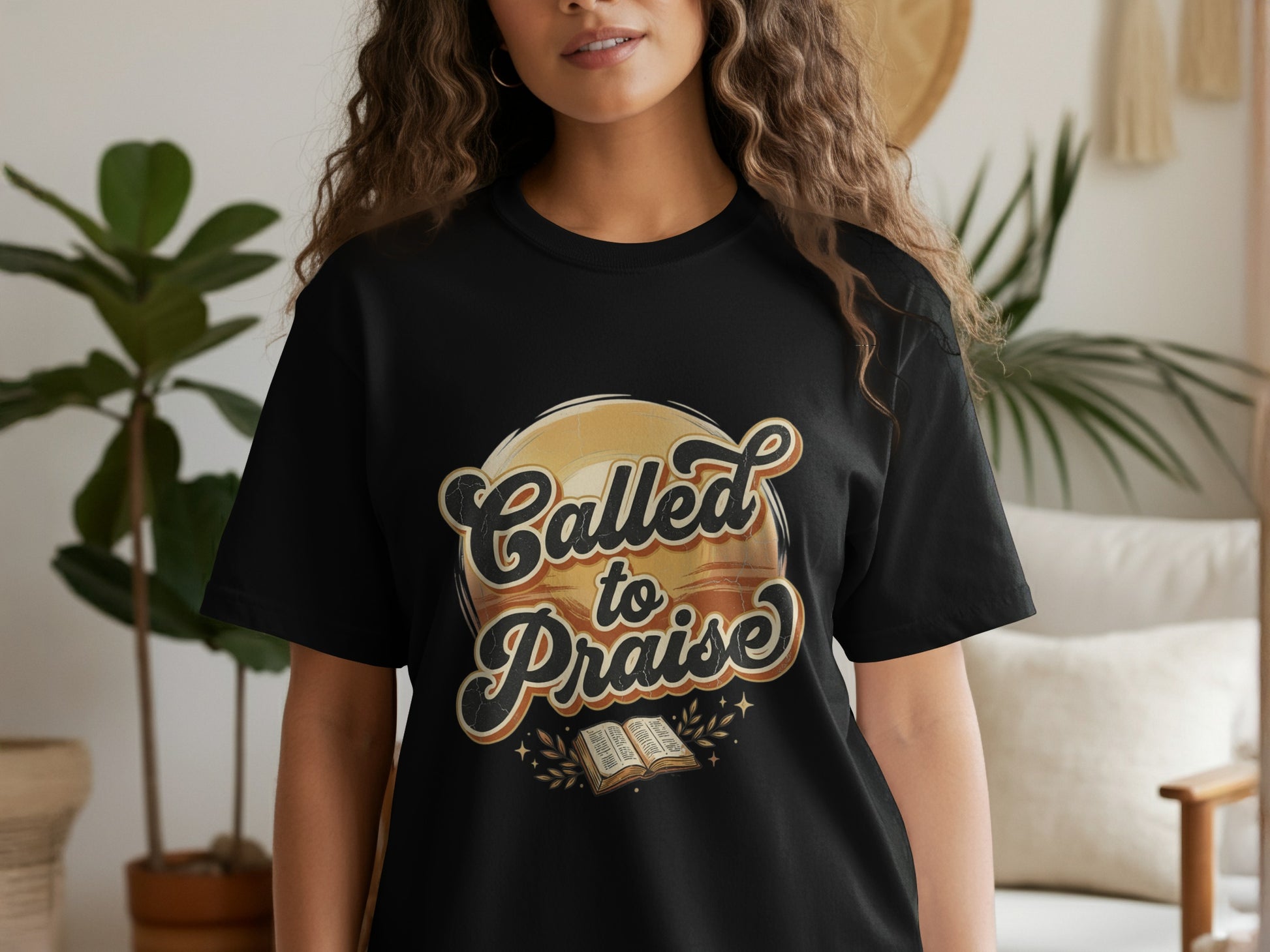 Black t-shirt with "Called to Praise" text and an open book graphic.