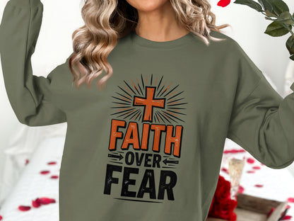 Olive green sweatshirt with "FAITH OVER FEAR" and a cross graphic.