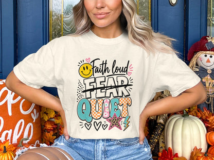 T-shirt with "Faith loud FEAR QUIET" text and smiley face, hearts, star, and lightning bolt graphics.