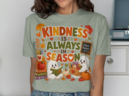 T-shirt design with ghosts, pumpkins, books, and the text "Kindness Is Always In Season".