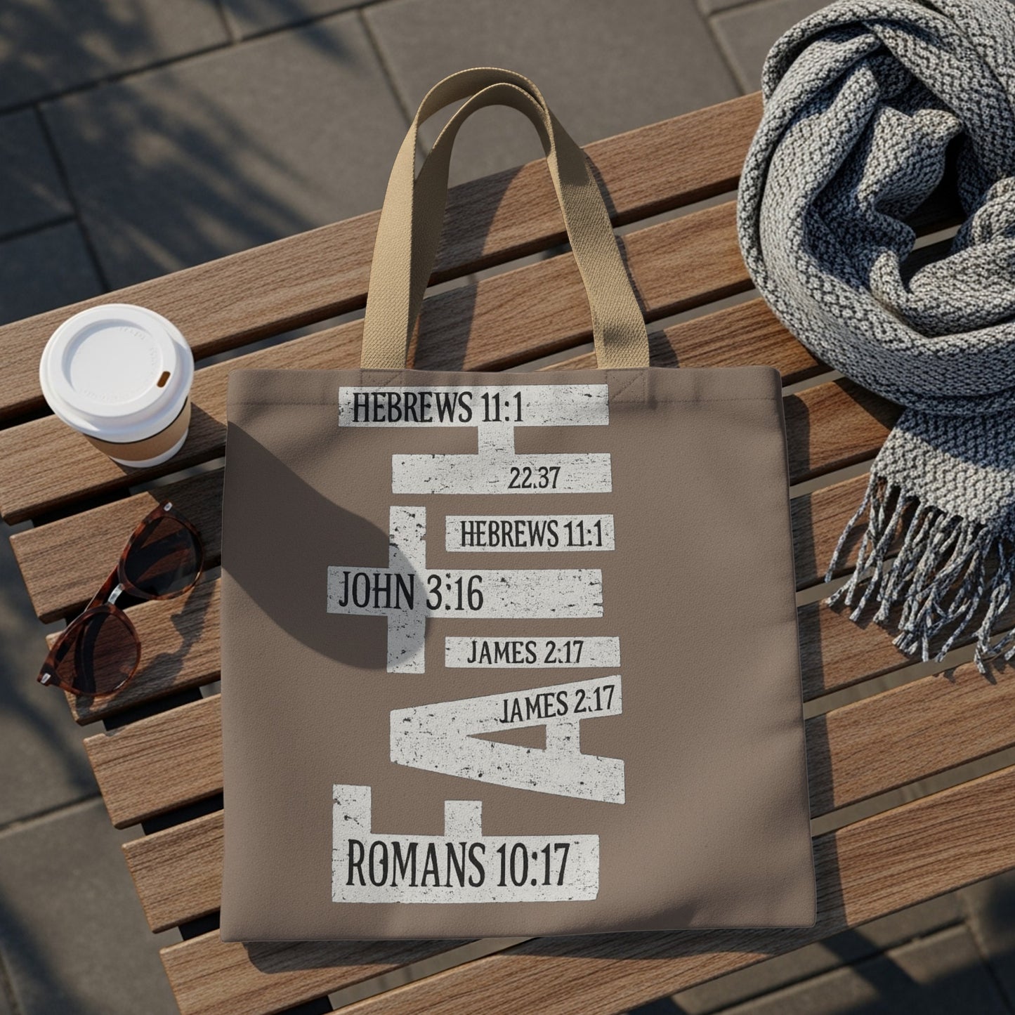 Taupe tote bag with distressed white text and Bible verses arranged in a cross shape.