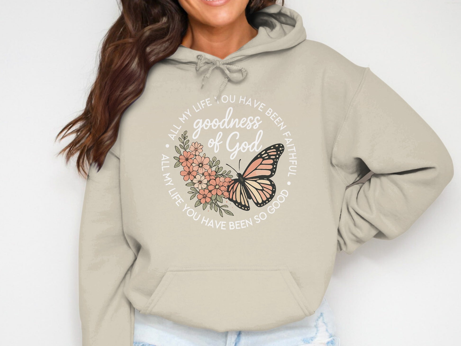 Beige hoodie with circular text and butterfly graphic.
