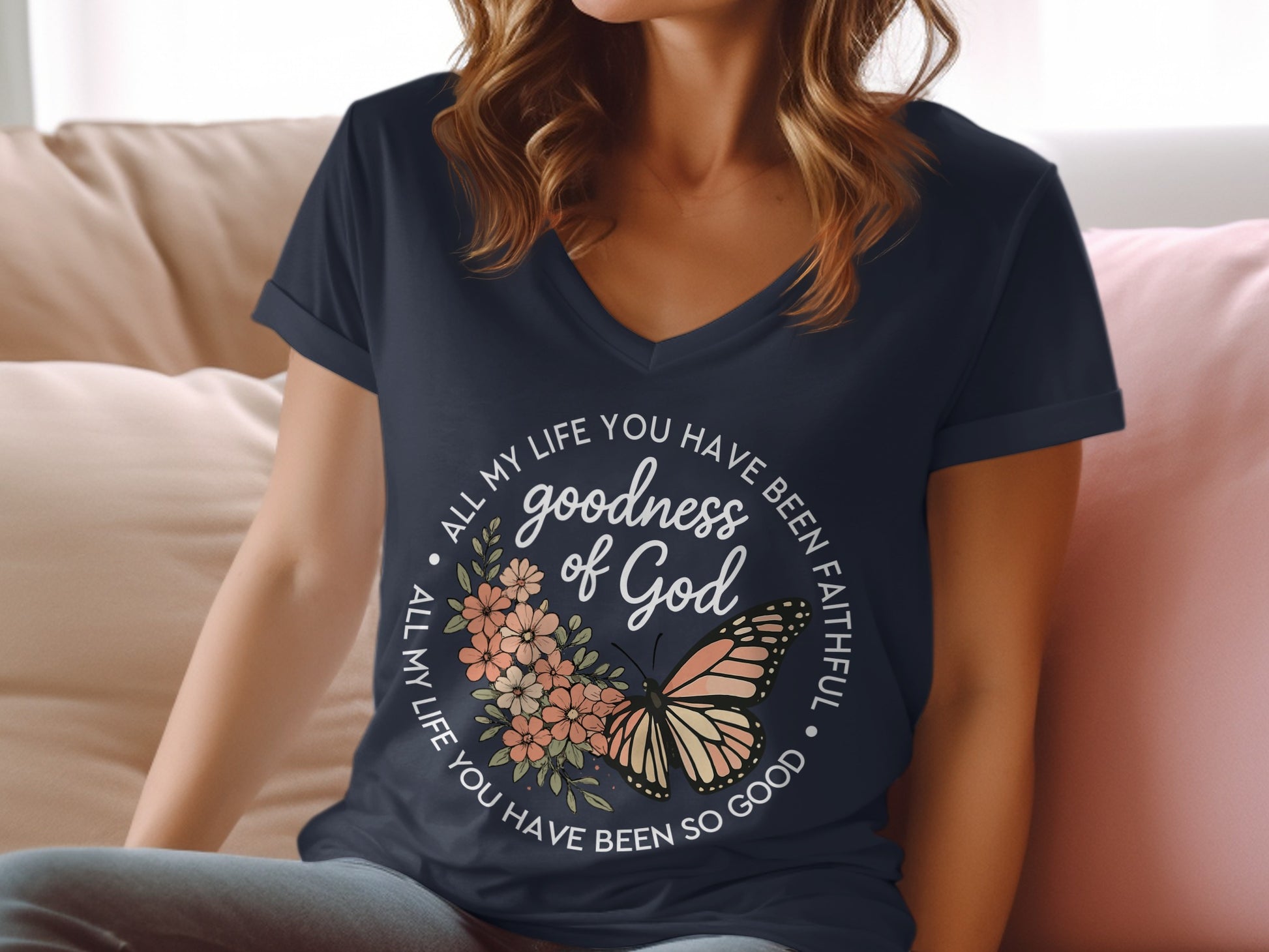 Navy v-neck t-shirt with "goodness of God" and butterfly graphic.