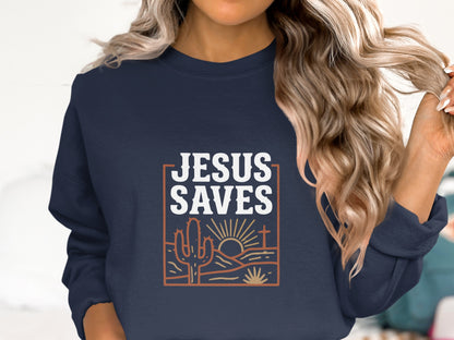 Navy sweatshirt with "Jesus Saves" text, desert landscape, and rising sun graphic.