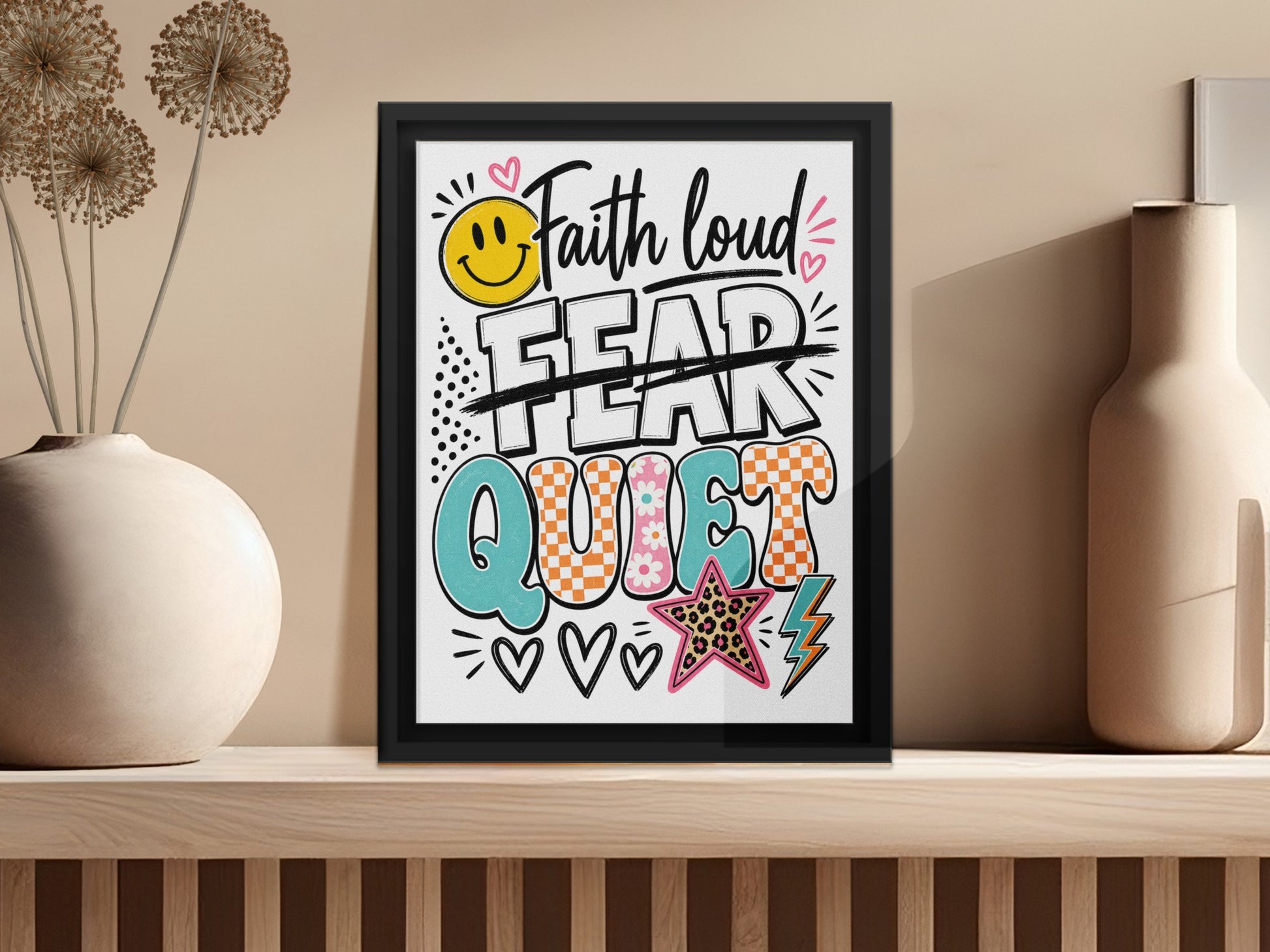 Framed art with "Faith loud FEAR quiet" text, smiley face, star, and lightning bolt.