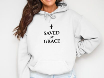 White hoodie with black text and cross: "SAVED BY GRACE".