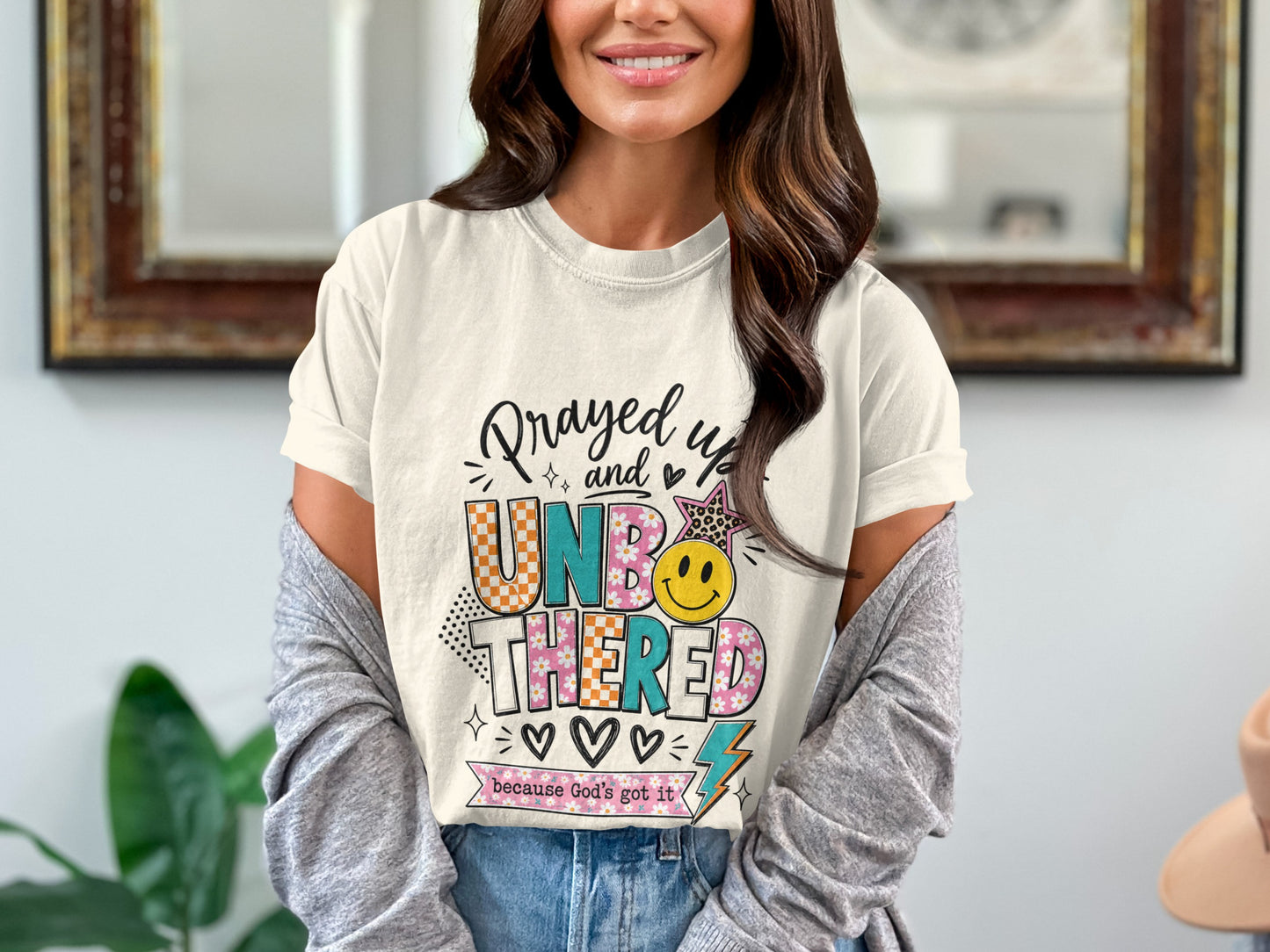 T-shirt with "Prayed up and Unbothered" graphic and "because God's got it" text.
