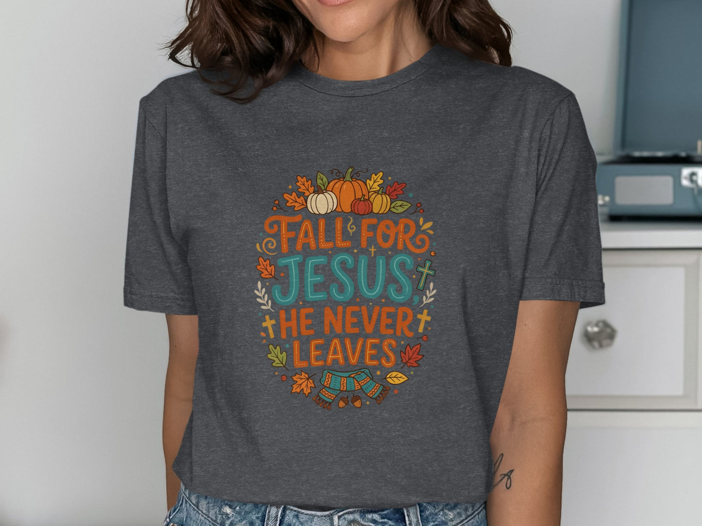 Dark grey t-shirt with "Fall for Jesus, He Never Leaves" text and autumn graphics.