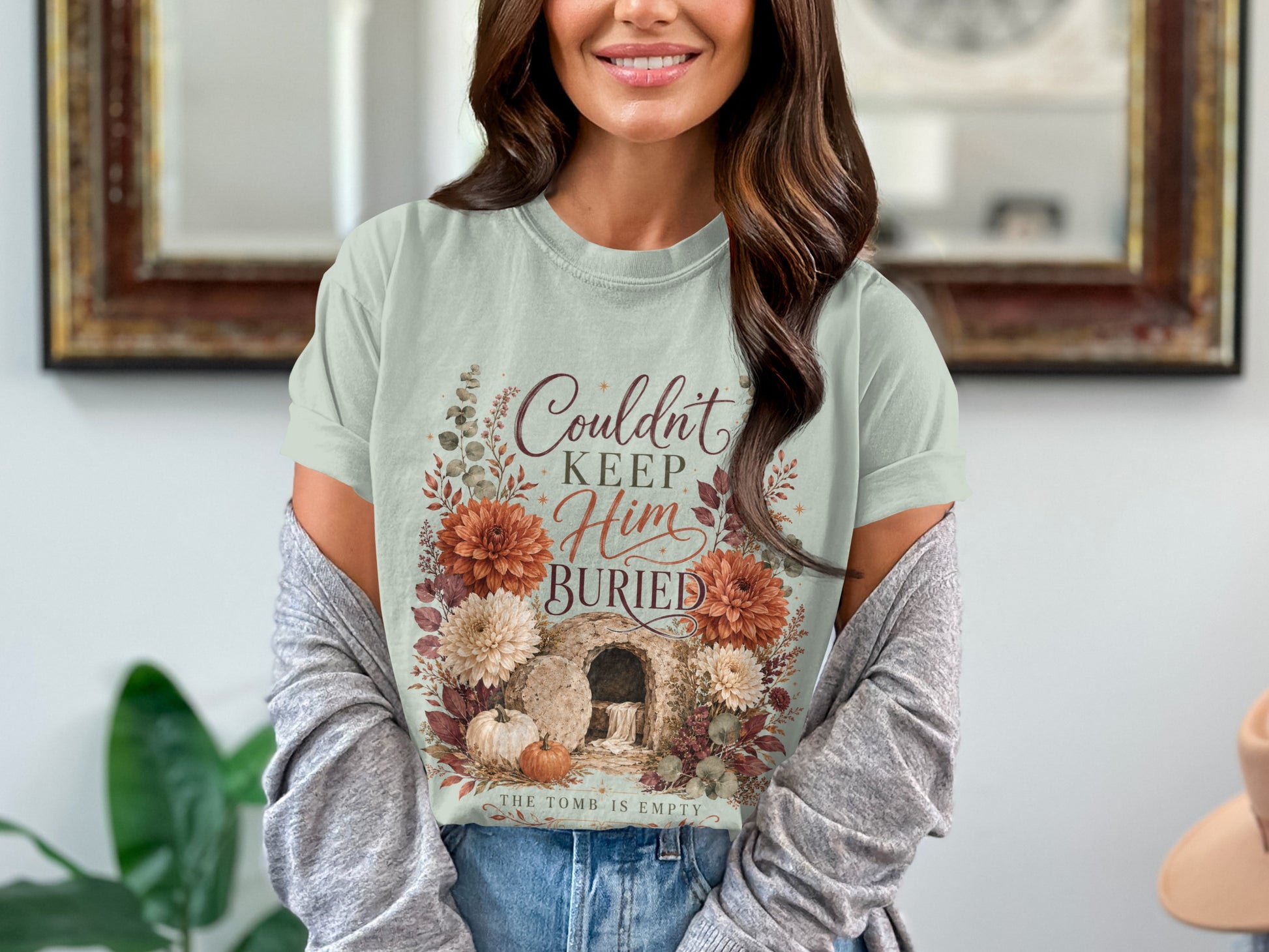 T-shirt with text "Couldn't Keep Him Buried. The Tomb is Empty."