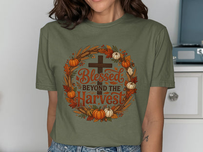 Olive green t-shirt with "Blessed Beyond the Harvest" cross and autumn wreath graphic.