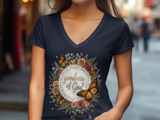 Dark t-shirt with circular floral design and text "goodness of God".