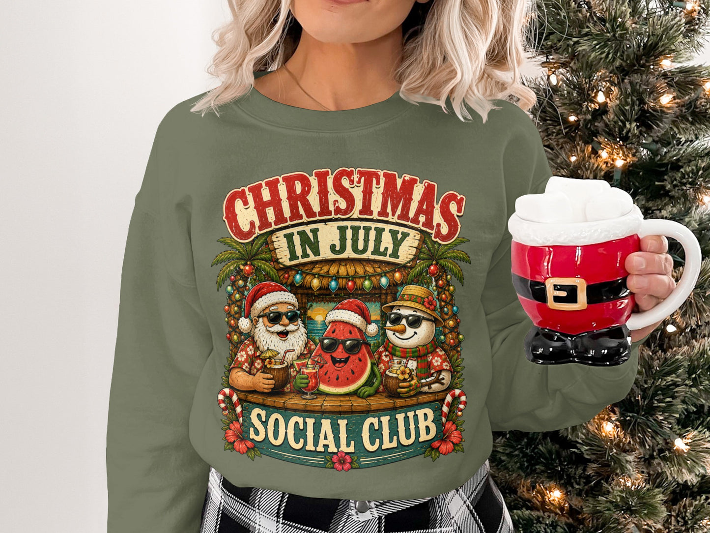 Christmas in July Social Club graphic on a green sweatshirt with tropical characters.