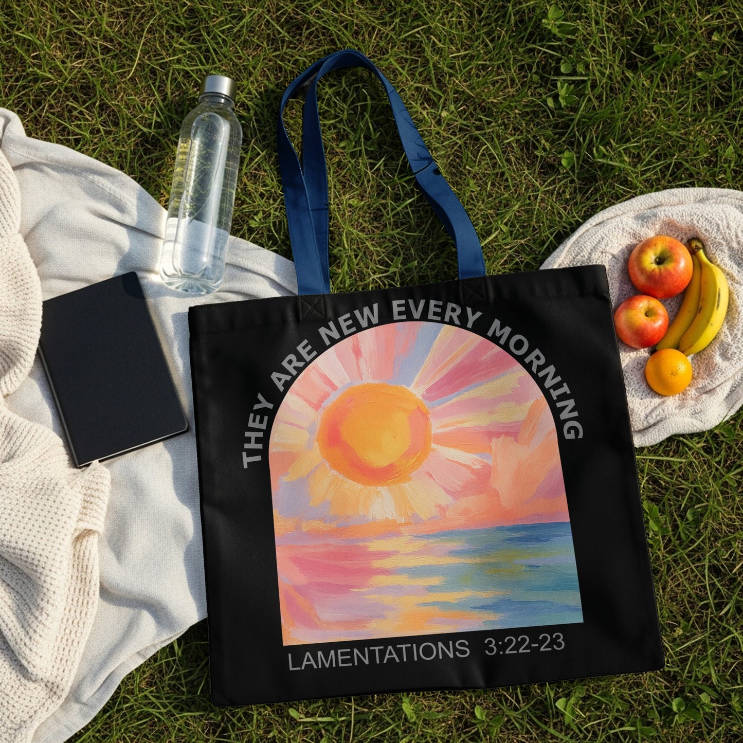 Black tote bag with painted sunrise over water, text "They are new every morning Lamentations 3:22-23".