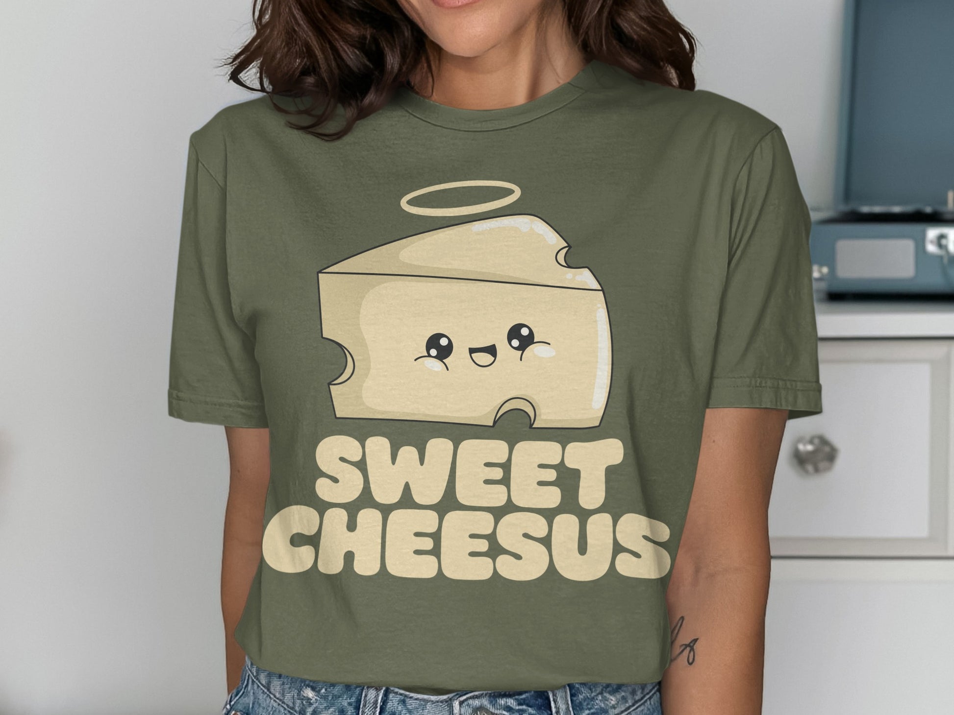 Green t-shirt with a smiling cheese slice graphic and "Sweet Cheesus" text.