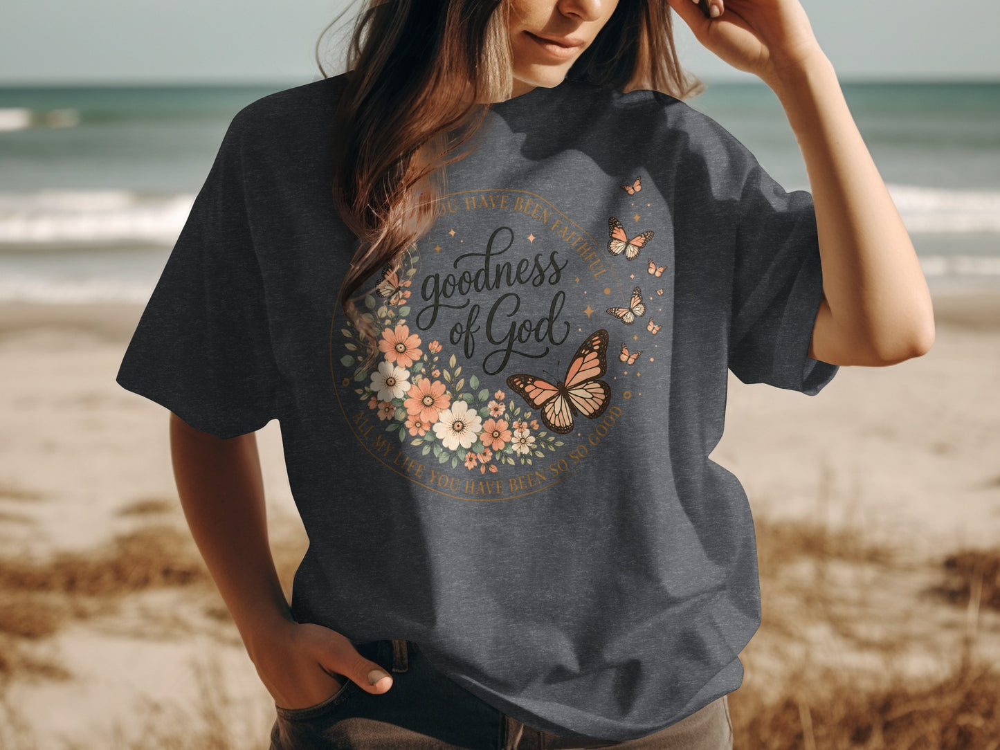 Dark grey t-shirt with floral and butterfly design and "goodness of God" text.