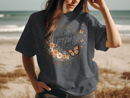 Dark grey t-shirt with floral and butterfly design and "goodness of God" text.