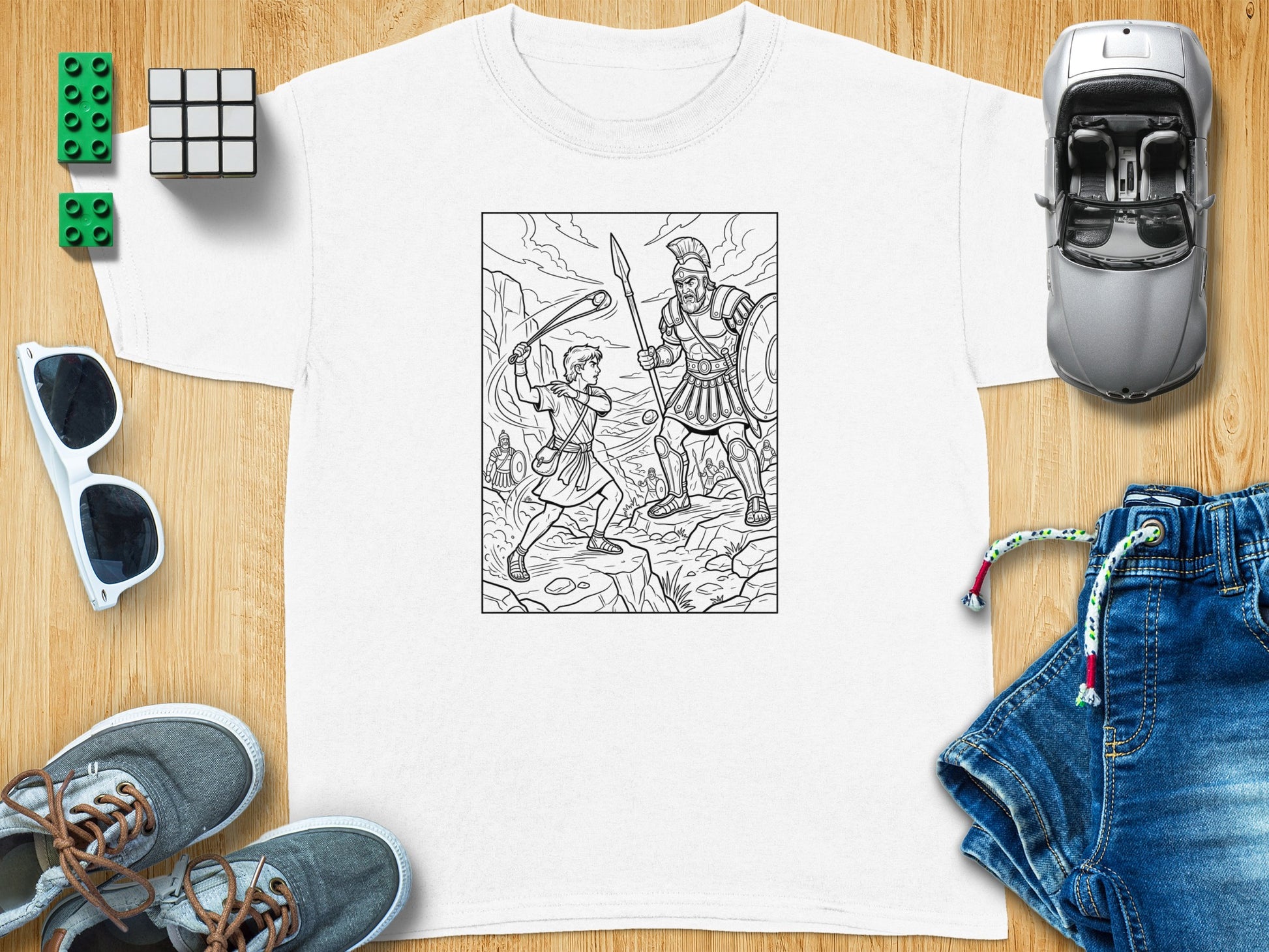 David and Goliath coloring illustration on a white t-shirt.