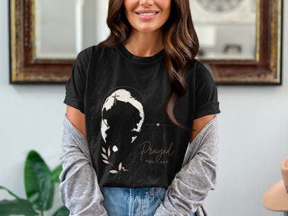 Black t-shirt with a world-like graphic and the word "Prayed".