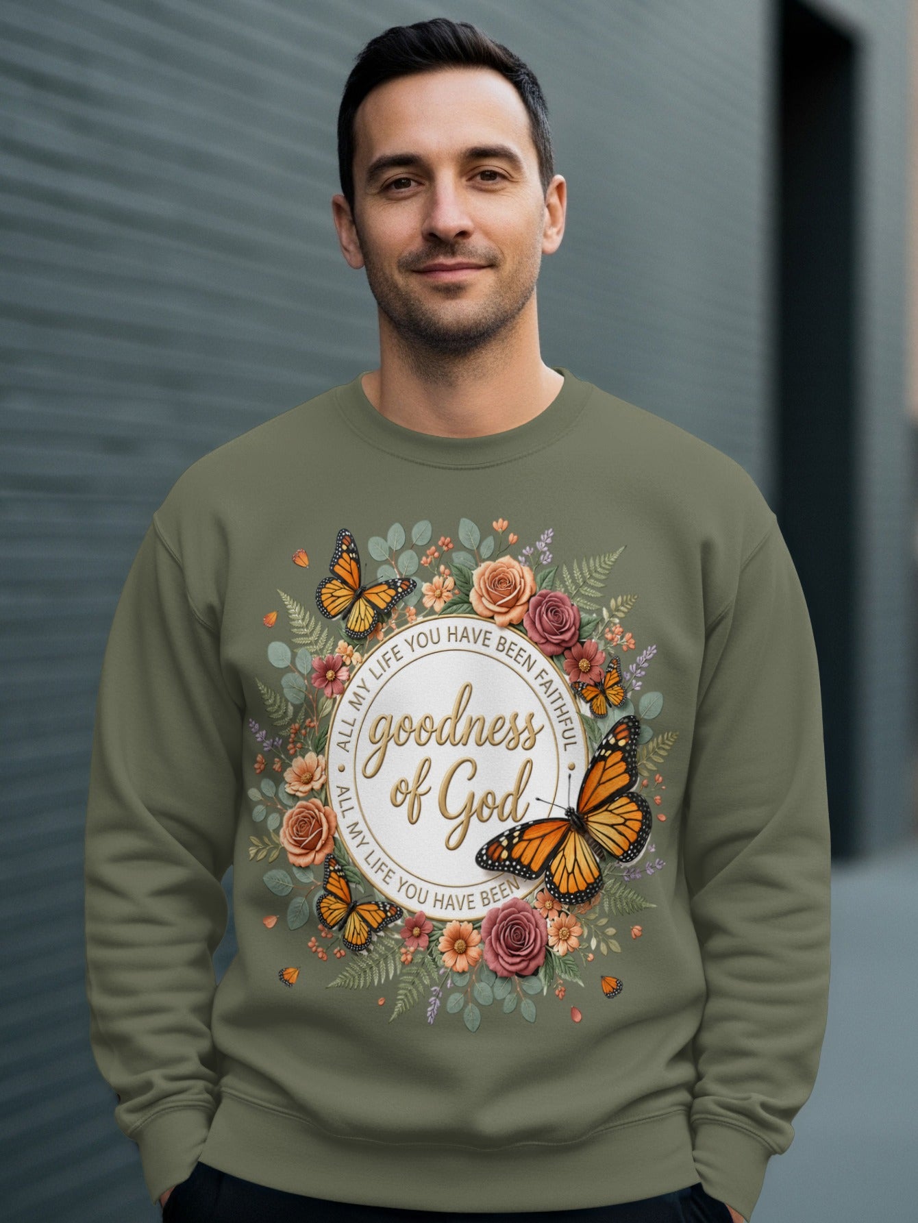 Green sweatshirt with "goodness of God" and floral butterfly design.