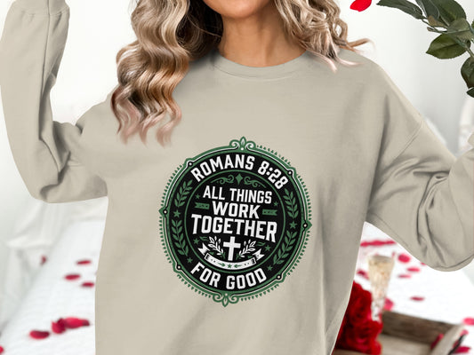 Crewneck sweatshirt with Romans 8:28 quote in circular green design.
