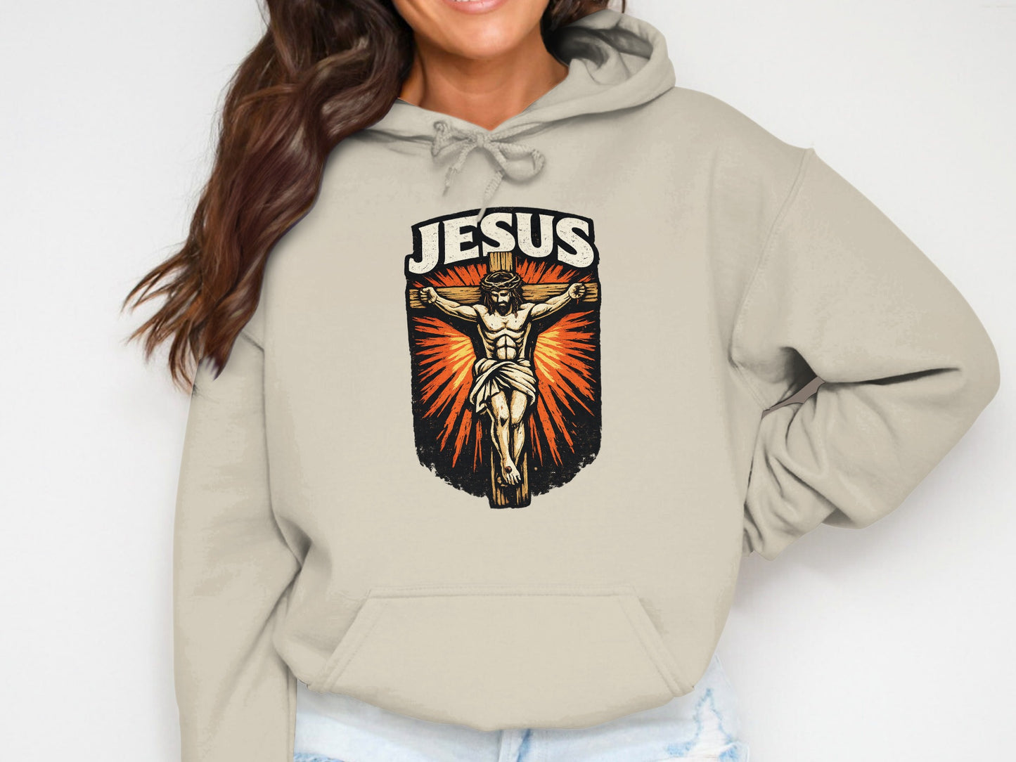 Jesus crucifixion graphic on a tan hooded sweatshirt.